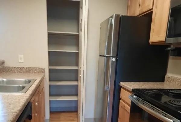 a kitchen with a refrigerator and a sink