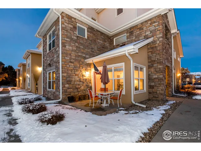 a backyard of a house with barbeque oven table and chairs