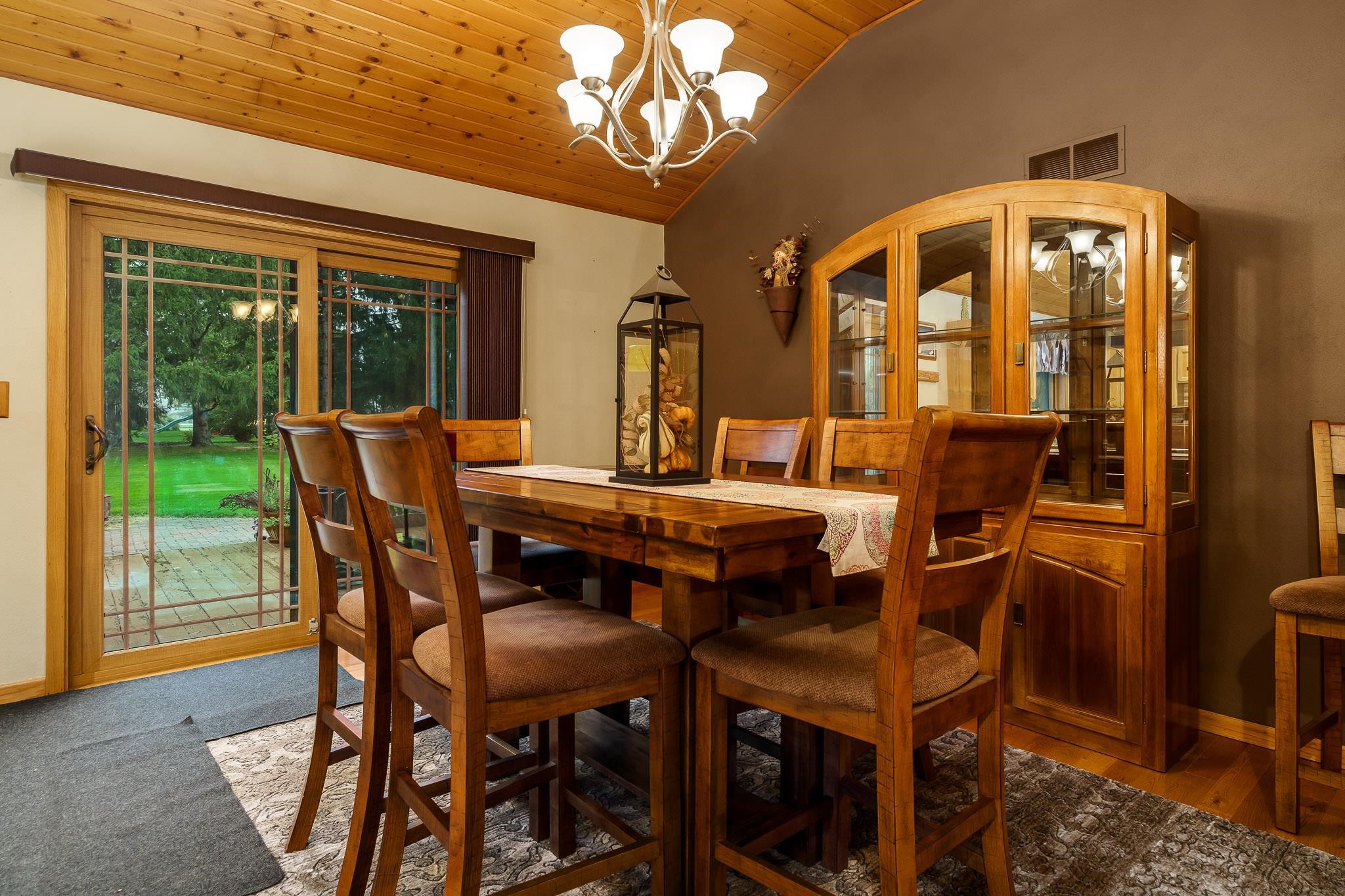 3942 Montclair Road Roscoe, IL 61073 - Photo 10 of 38 a view of a dining room with furniture wooden floor and chandelier