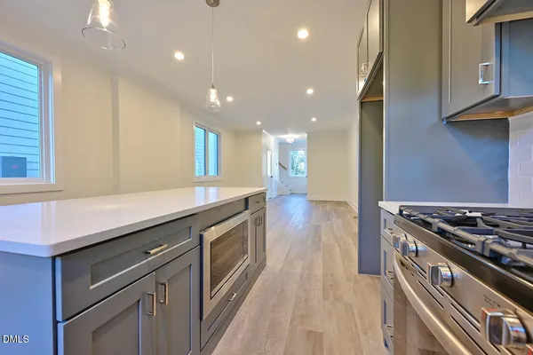 a kitchen with stainless steel appliances granite countertop a stove and a sink