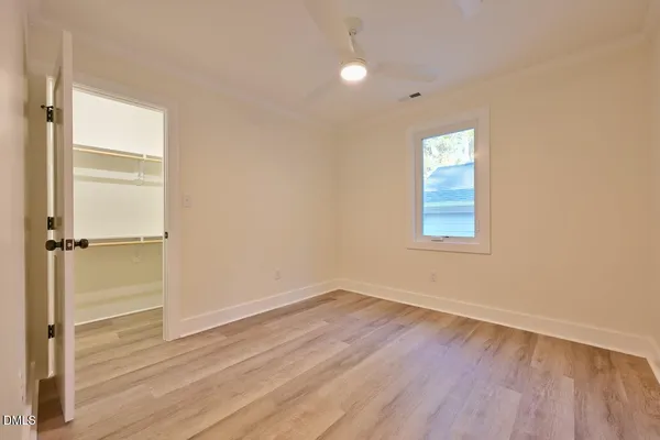 a view of a room with wooden floor and window
