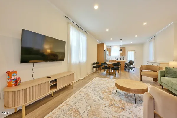 a living room with furniture and a wooden floor