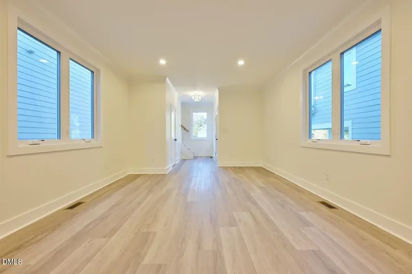 a view of a room with wooden floor and windows
