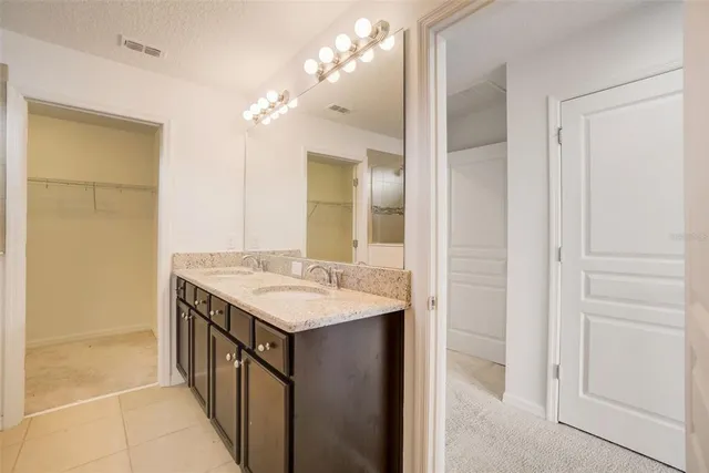 a bathroom with a sink mirror and shower