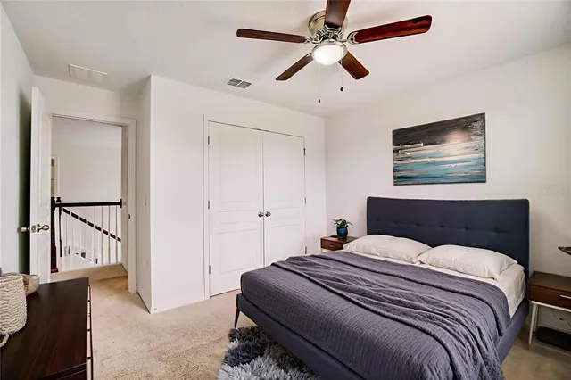 a bedroom with a large bed and a chandelier