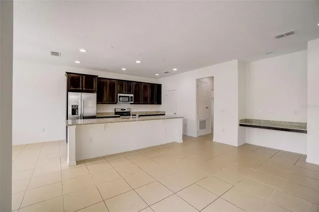 a view of kitchen with stainless steel appliances cabinets