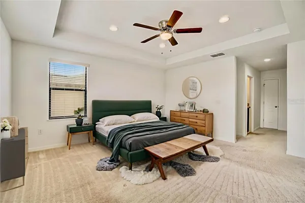a bedroom with a bed and a chandelier
