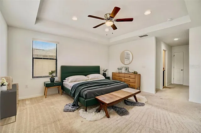 a bedroom with a bed and a chandelier