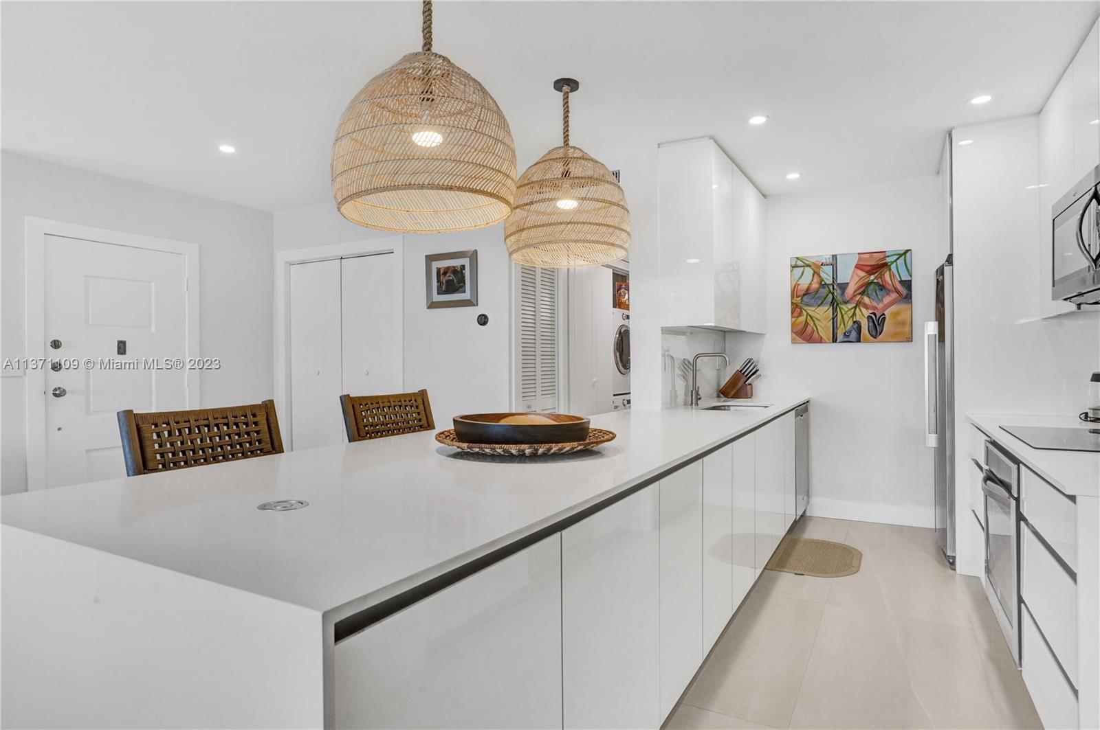 166 Harbor Drive, Unit 3C Key Biscayne, FL 33149 - Photo 16 of 78 a kitchen with stainless steel appliances a stove a sink a refrigerator and a refrigerator