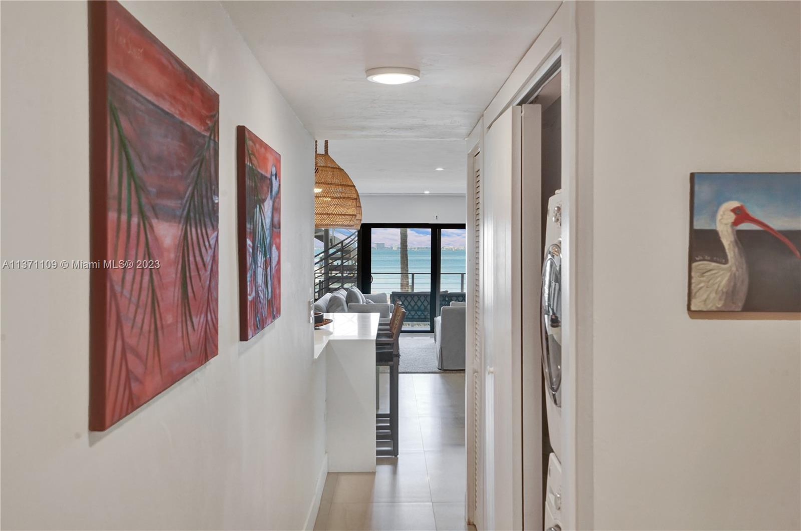166 Harbor Drive, Unit 3C Key Biscayne, FL 33149 - Photo 18 of 78 a view of a hallway with wooden floor and staircase