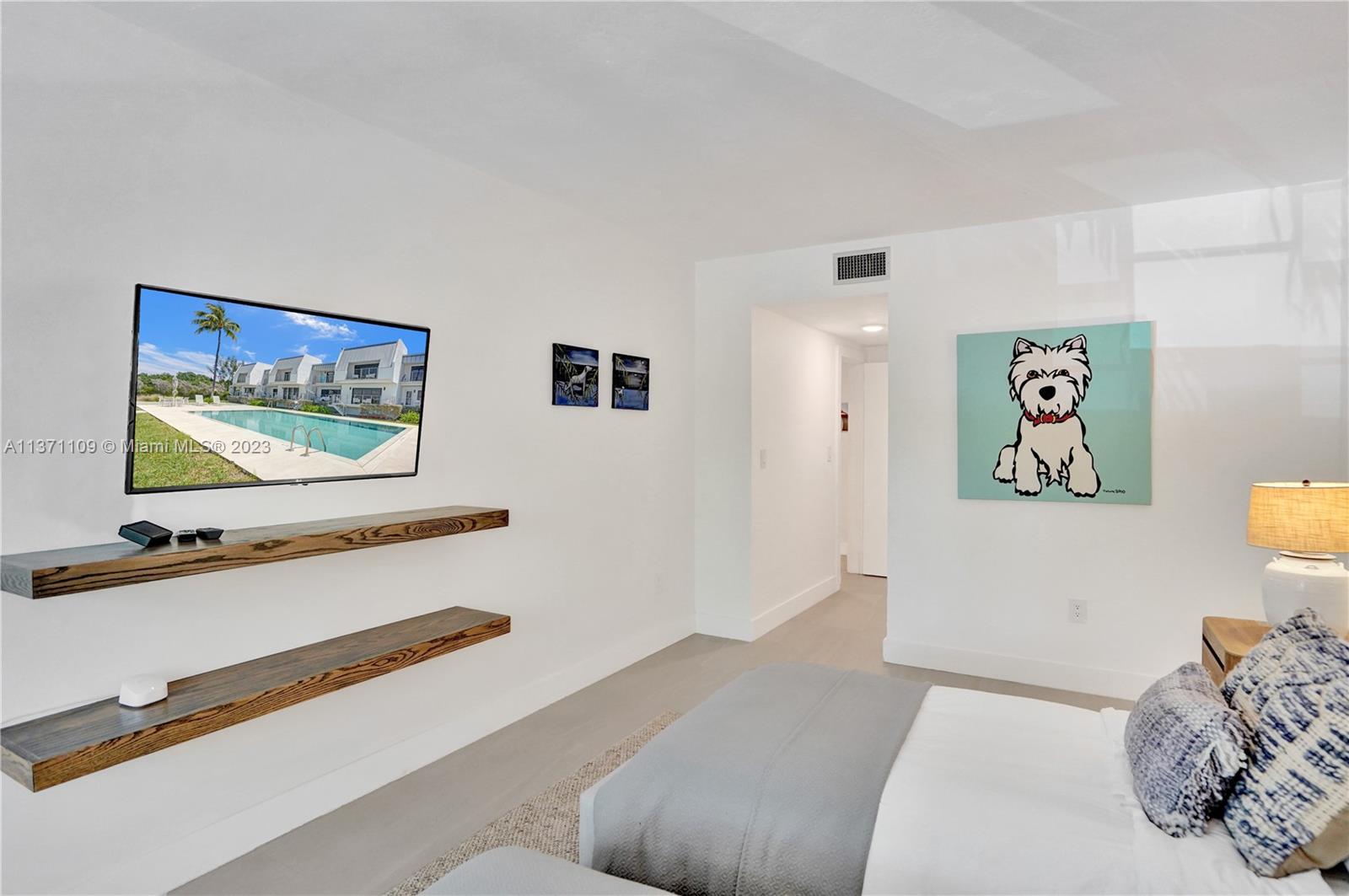 166 Harbor Drive, Unit 3C Key Biscayne, FL 33149 - Photo 29 of 78 a bedroom with a bed and wall painting