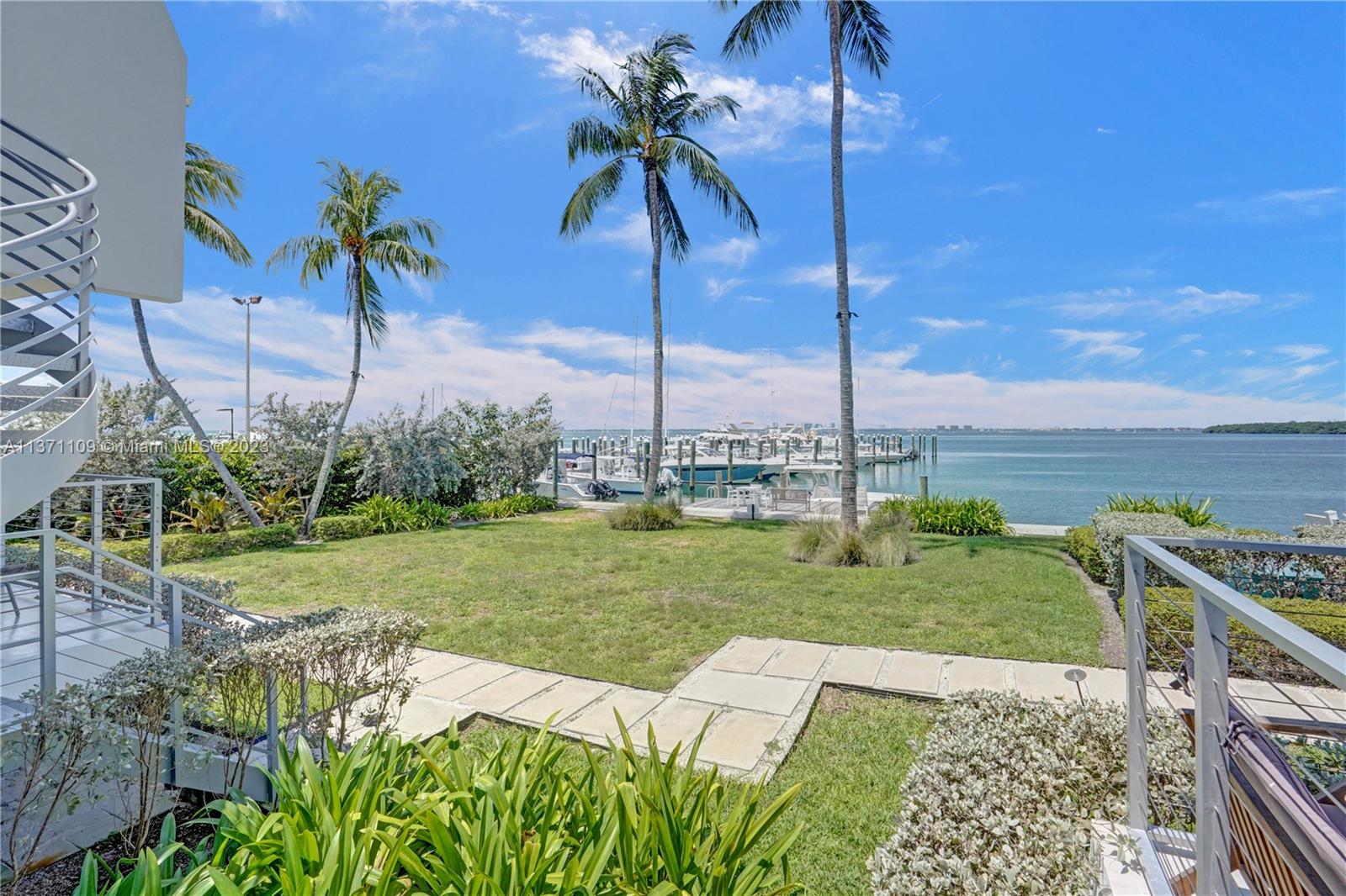 166 Harbor Drive, Unit 3C Key Biscayne, FL 33149 - Photo 35 of 78 a view of a garden with lawn chairs