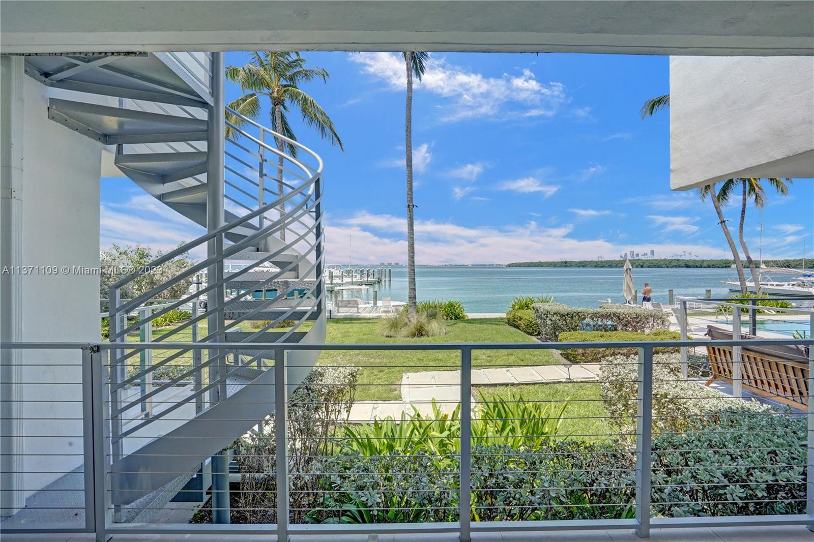 166 Harbor Drive, Unit 3C Key Biscayne, FL 33149 - Photo 36 of 78 a view of a swimming pool with a yard and sitting area