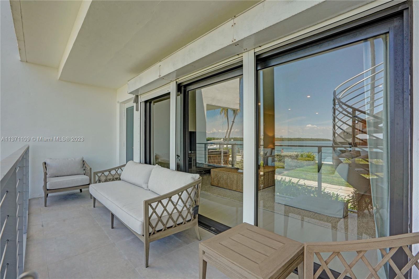 166 Harbor Drive, Unit 3C Key Biscayne, FL 33149 - Photo 40 of 78 a living room with furniture and a window