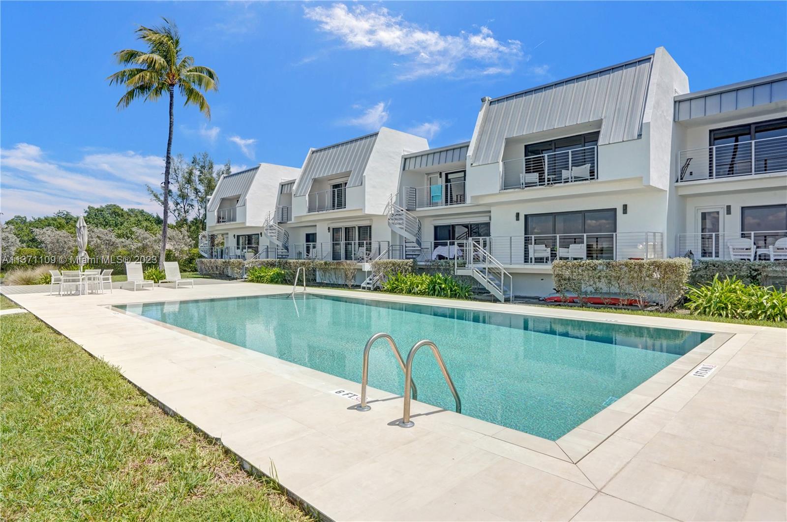 166 Harbor Drive, Unit 3C Key Biscayne, FL 33149 - Photo 56 of 78 a swimming pool with outdoor seating and yard