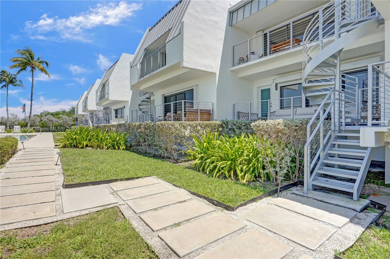 166 Harbor Drive, Unit 3C Key Biscayne, FL 33149 - Photo 57 of 78 a front view of a house with garden