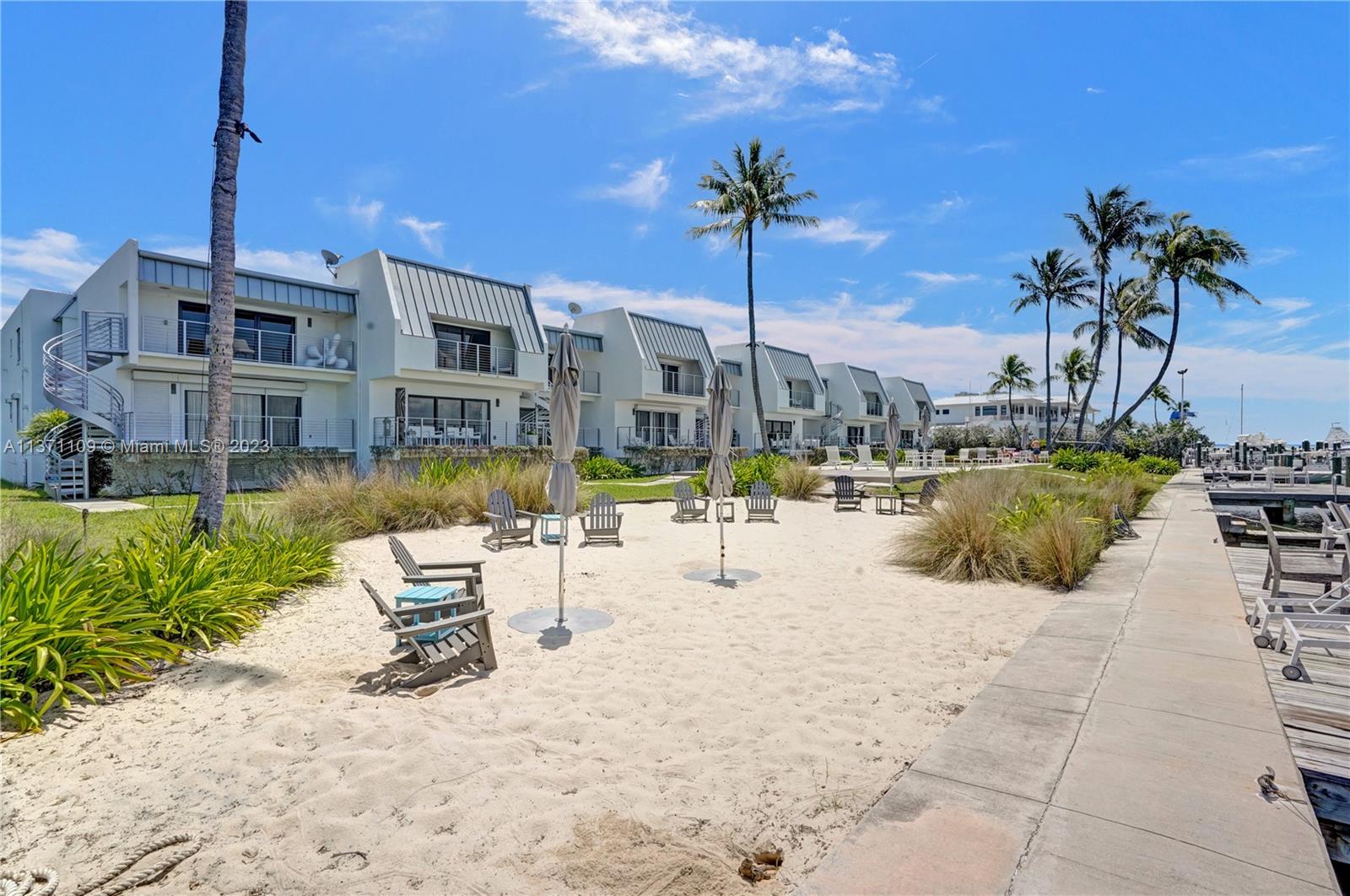 166 Harbor Drive, Unit 3C Key Biscayne, FL 33149 - Photo 60 of 78 a view of a swimming pool with a chair