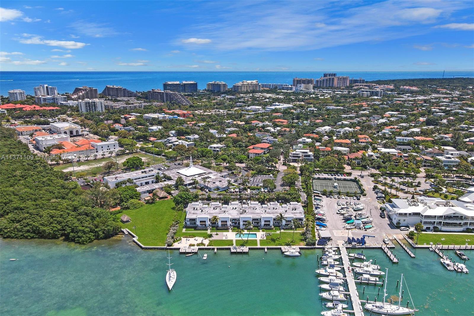 166 Harbor Drive, Unit 3C Key Biscayne, FL 33149 - Photo 73 of 78 an aerial view of a city with lots of residential buildings and mountain view in back