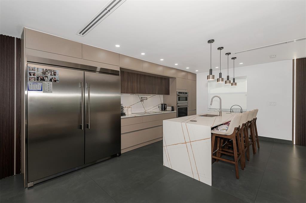a kitchen with refrigerator cabinets and wooden floor