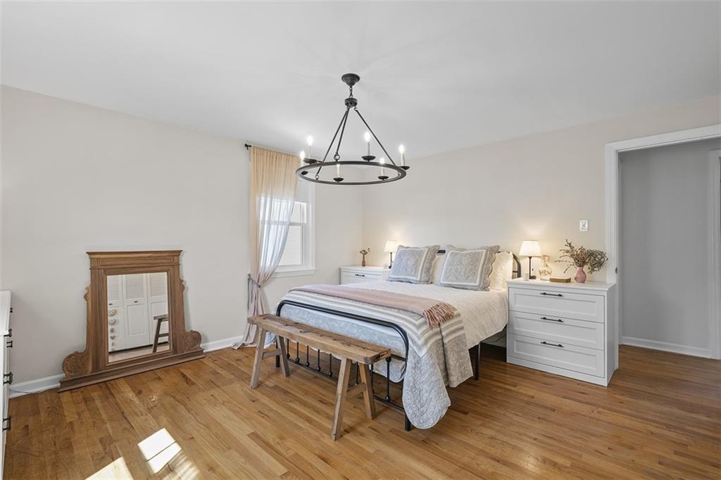 215 McIntyre Road Pittsburgh, PA 15237 - Photo 11 of 28 a bedroom with a bed and a chandelier