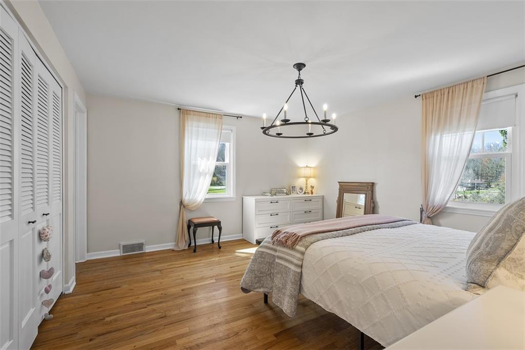 215 McIntyre Road Pittsburgh, PA 15237 - Photo 12 of 28 a bedroom with a bed and a chandelier