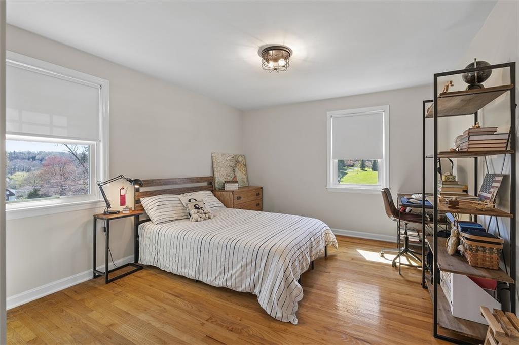 215 McIntyre Road Pittsburgh, PA 15237 - Photo 15 of 28 a bedroom with a bed a table and three windows