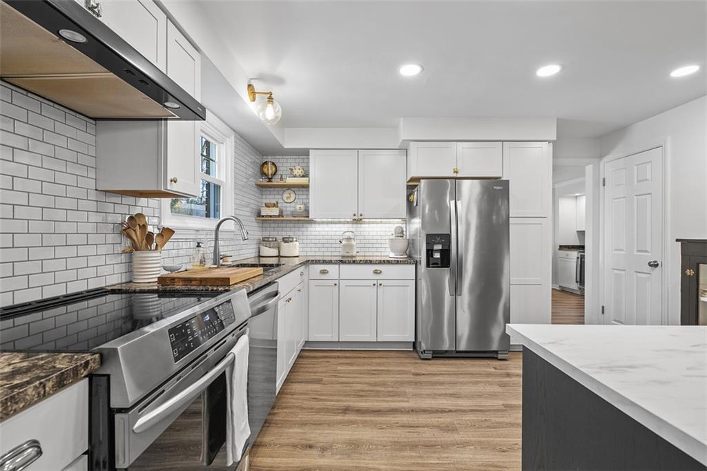 215 McIntyre Road Pittsburgh, PA 15237 - Photo 3 of 28 a kitchen with stainless steel appliances granite countertop a sink stove and refrigerator