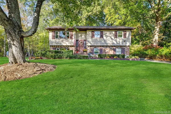 a view of a house with a yard and sitting area