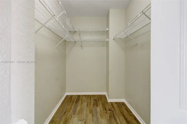 a view of a room with wooden floor