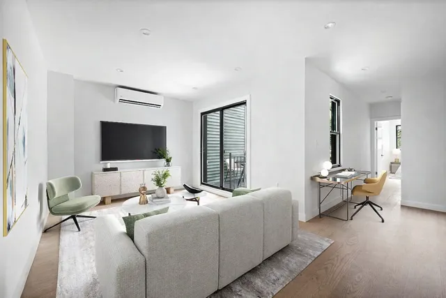 a living room with a couch and a stove top oven