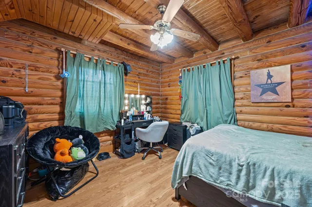 a bedroom with furniture and a large window