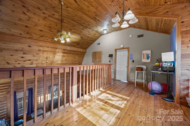 a view of a porch with wooden floor and furniture