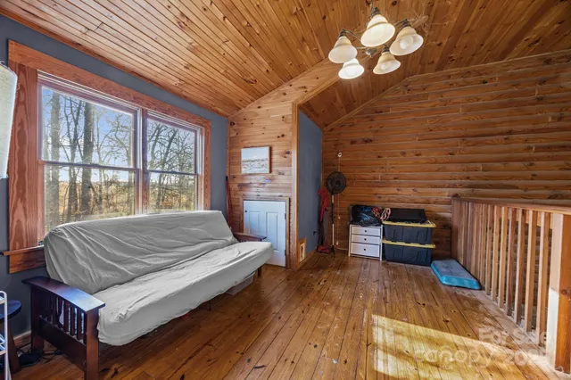 a bed sitting in a spacious bedroom next to a window