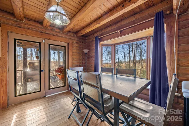 a dining room with furniture wooden floor and a chandelier