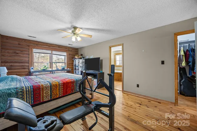 a spacious bedroom with a bed and a chandelier