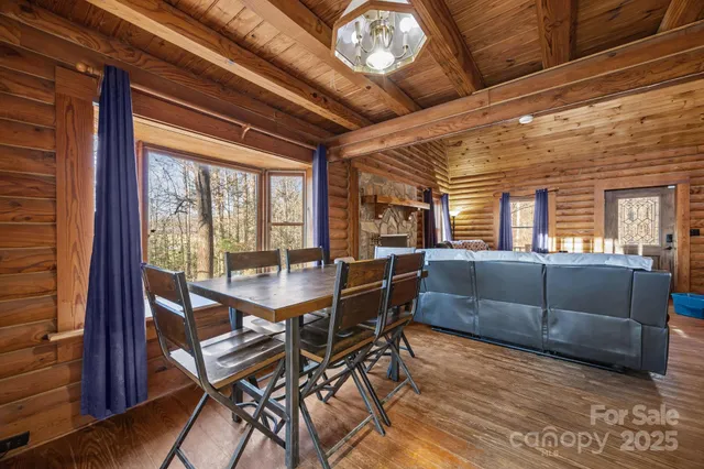 a dining room with furniture a chandelier and wooden floor