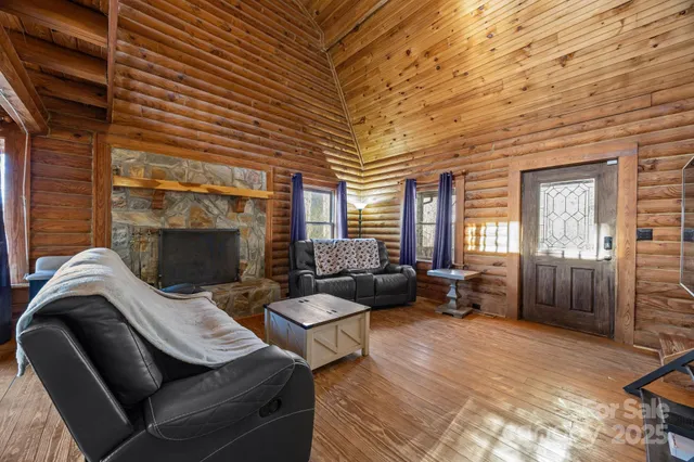 a living room with furniture a fireplace and a table