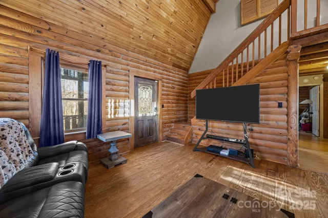 a living room with furniture a flat screen tv and a window