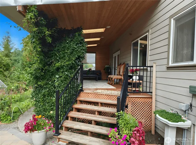 a view of a patio with table and chairs and potted plants
