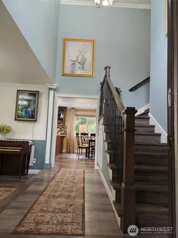 a view of a hallway view with furniture and fireplace