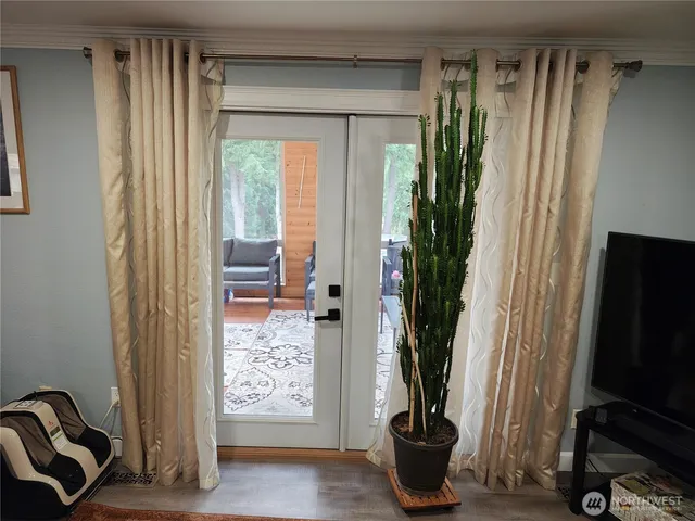 a view of a livingroom with furniture and a window
