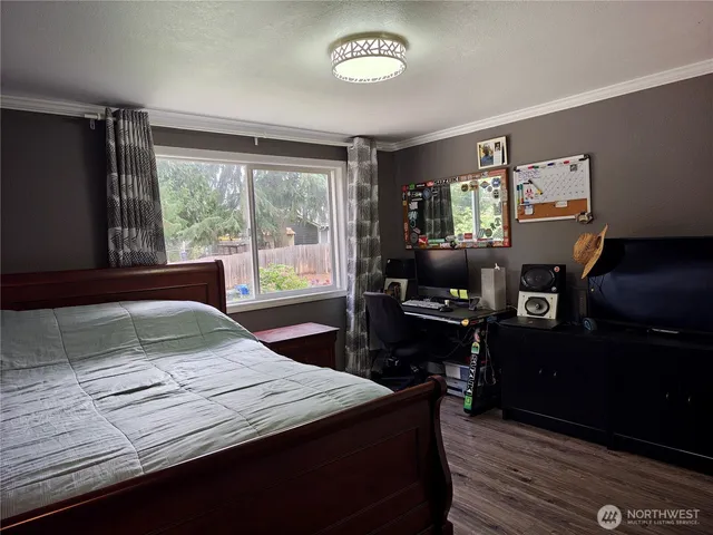 a bed sitting in a bedroom next to a window