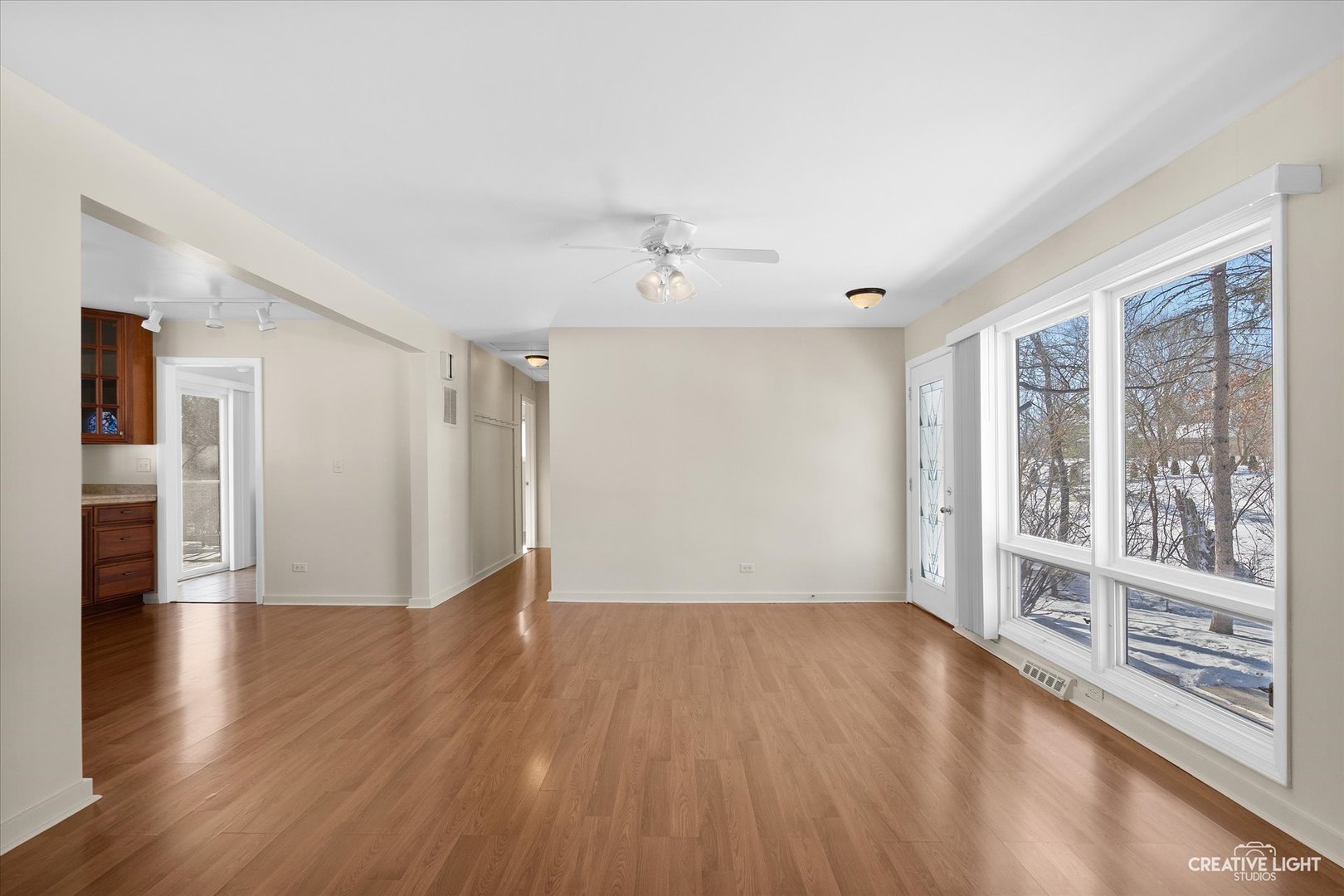 5S621 Radcliff Road Naperville, IL 60563 - Photo 13 of 27 a view of an empty room with wooden floor and a window