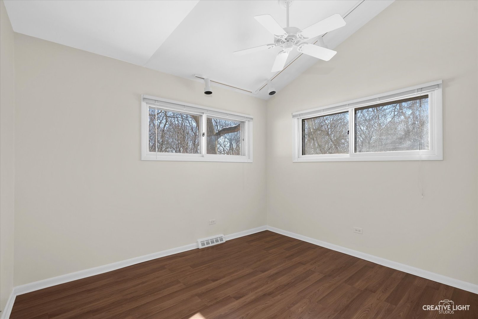 5S621 Radcliff Road Naperville, IL 60563 - Photo 19 of 27 a view of an empty room with wooden floor and a ceiling fan