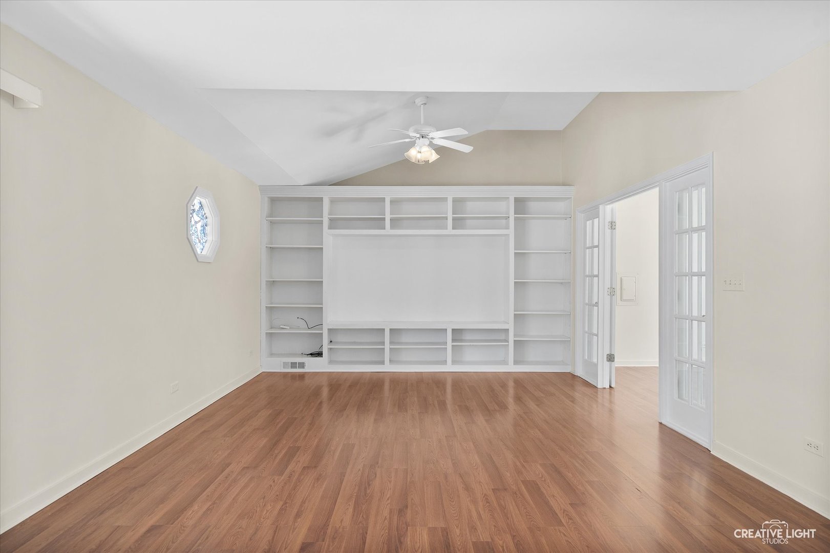5S621 Radcliff Road Naperville, IL 60563 - Photo 8 of 27 an empty room with wooden floor and windows