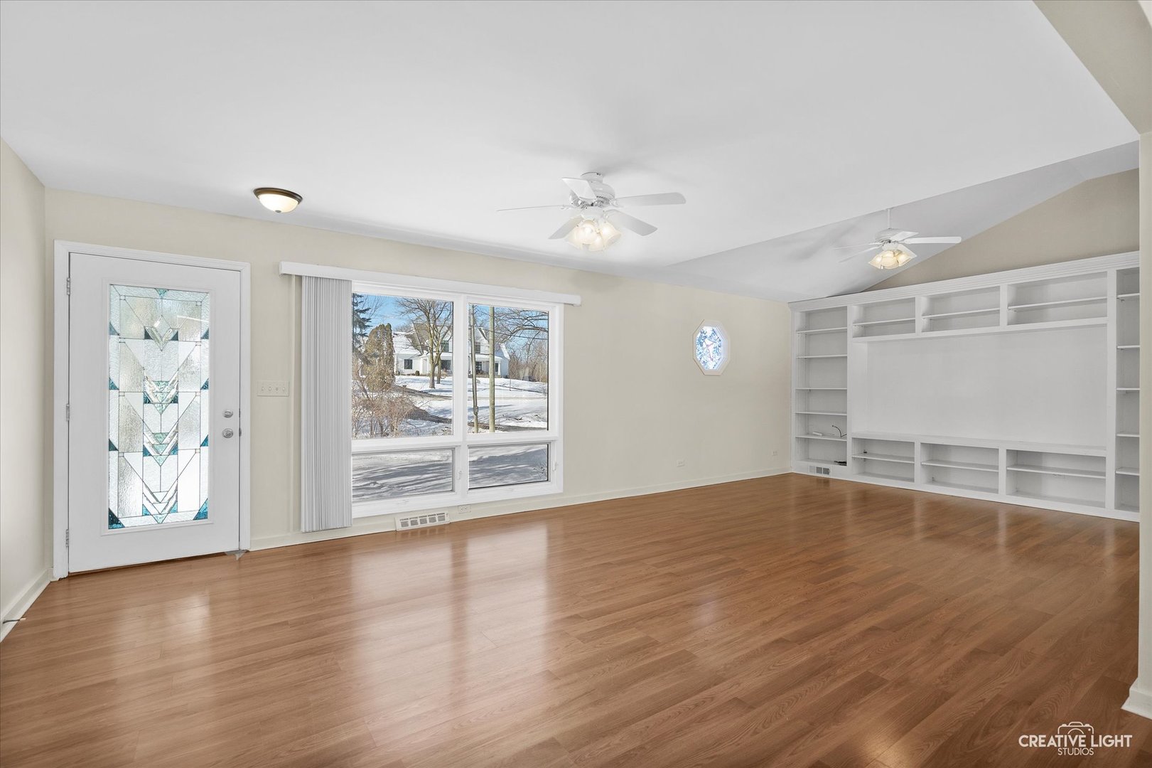 5S621 Radcliff Road Naperville, IL 60563 - Photo 9 of 27 a view of an empty room with window and wooden floor