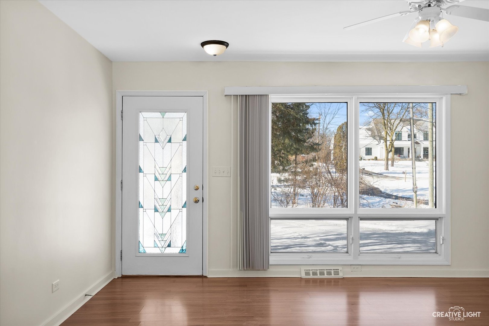 5S621 Radcliff Road Naperville, IL 60563 - Photo 10 of 27 an empty room with wooden floor and windows