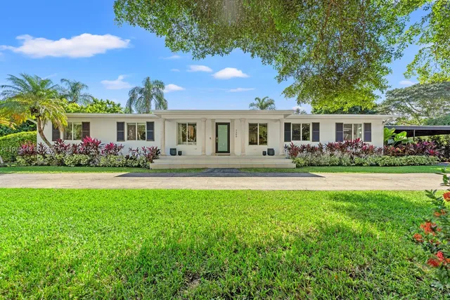 a front view of house with yard and green space