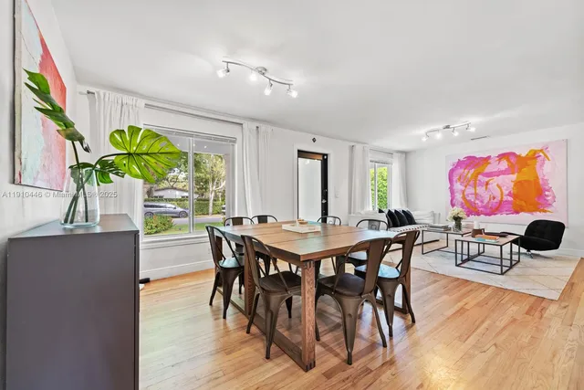 a view of a dining room with furniture and wooden floor