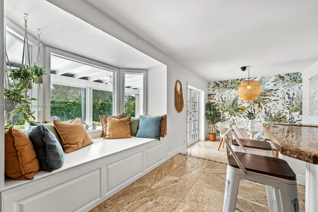 a kitchen with stainless steel appliances kitchen island granite countertop a table and chairs in it